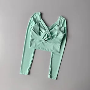 Light green long-sleeve top on a gray background