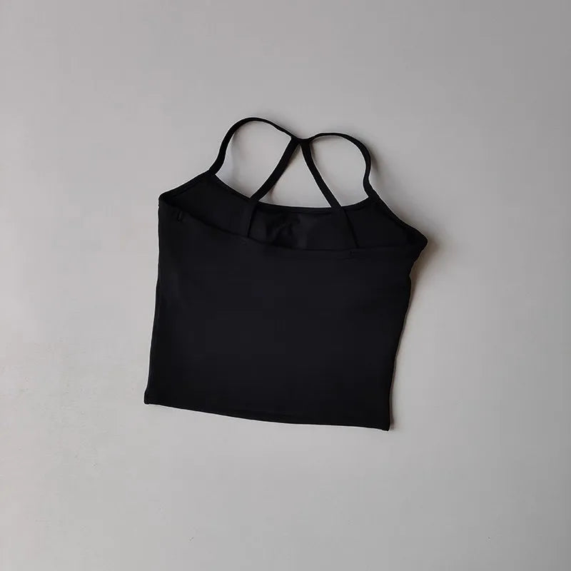 Black crop top with thin straps on a light gray background