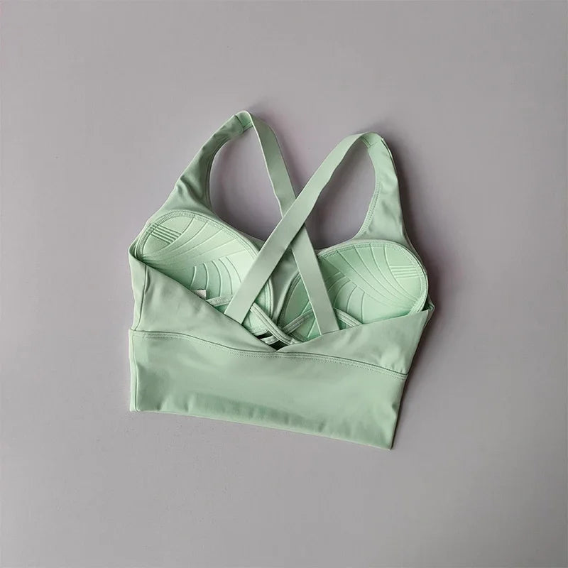 Light green sports bra on a gray background