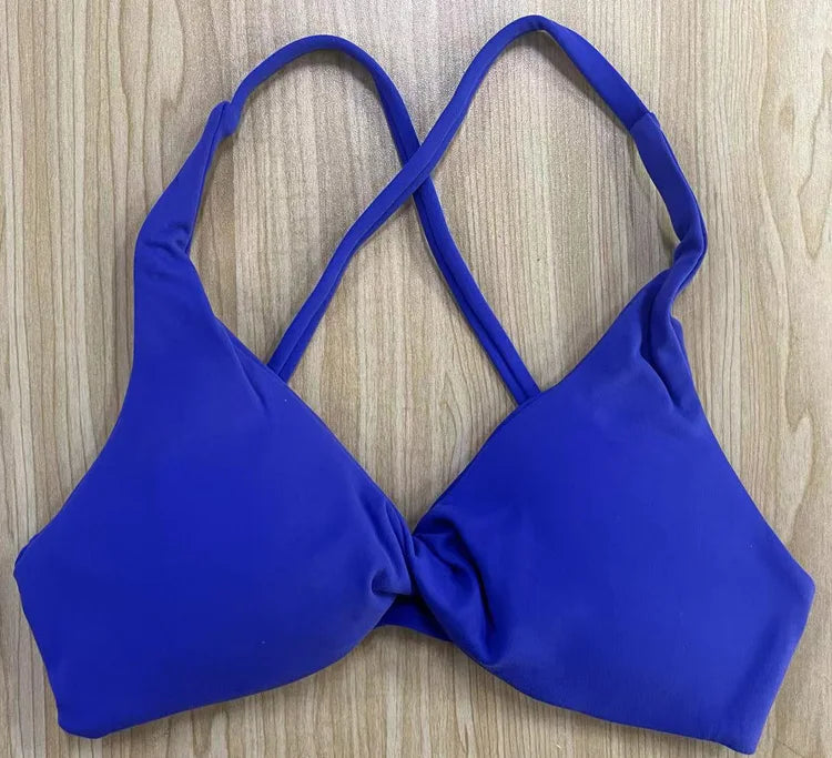 Blue bikini top on a wooden surface