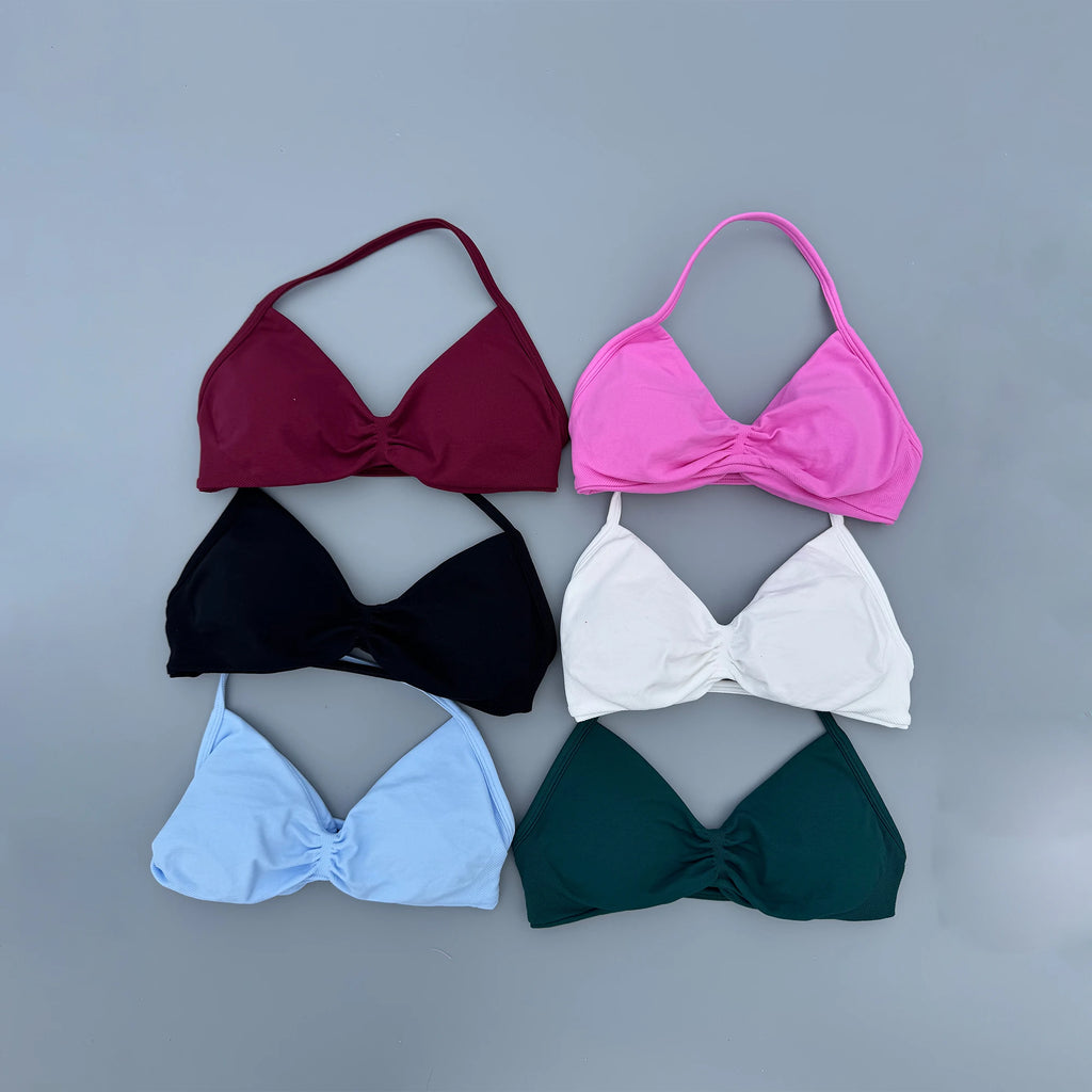 Six women's bikini halter tops in different colors are arranged in a 2x3 grid on a solid gray background. The colors are burgundy, bright pink, black, white, light blue, and dark green.