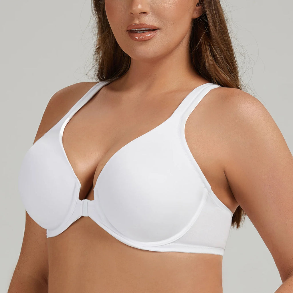 Woman wearing a white bra against a plain background
