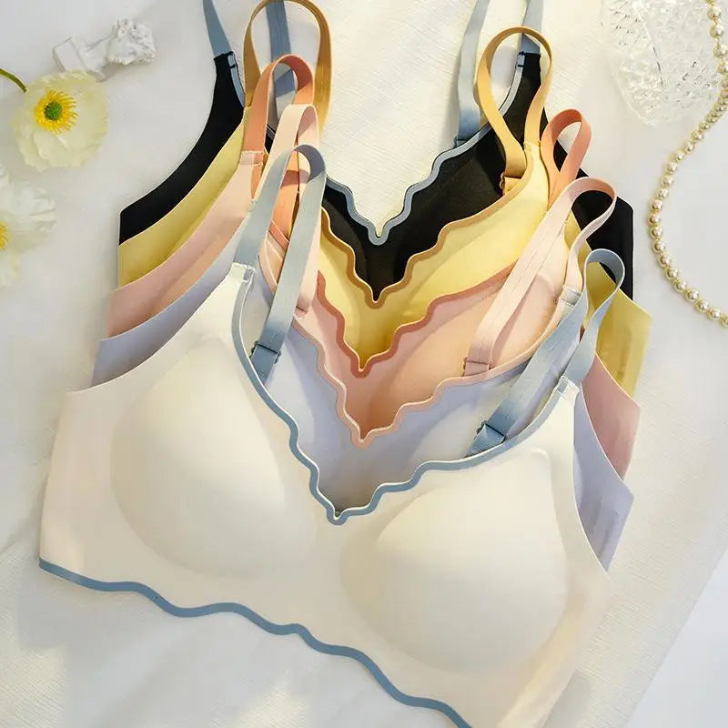 Set of colorful bras displayed on a white surface with decorative elements.