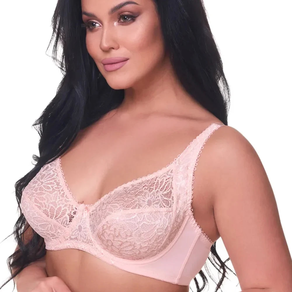 Woman wearing a pink lace bra on a white background