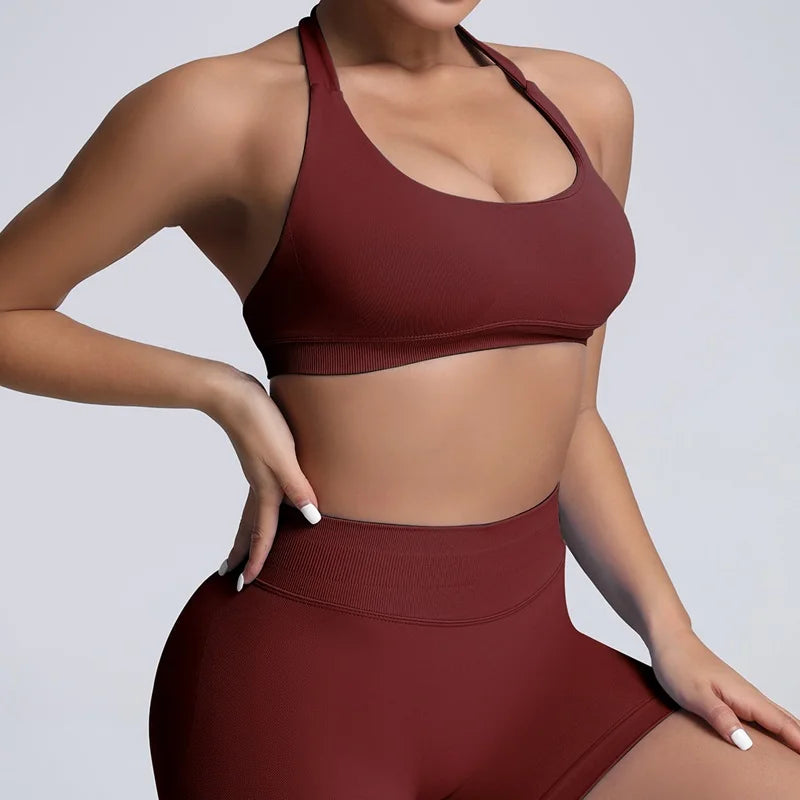 Maroon sports bra and leggings set on a plain background