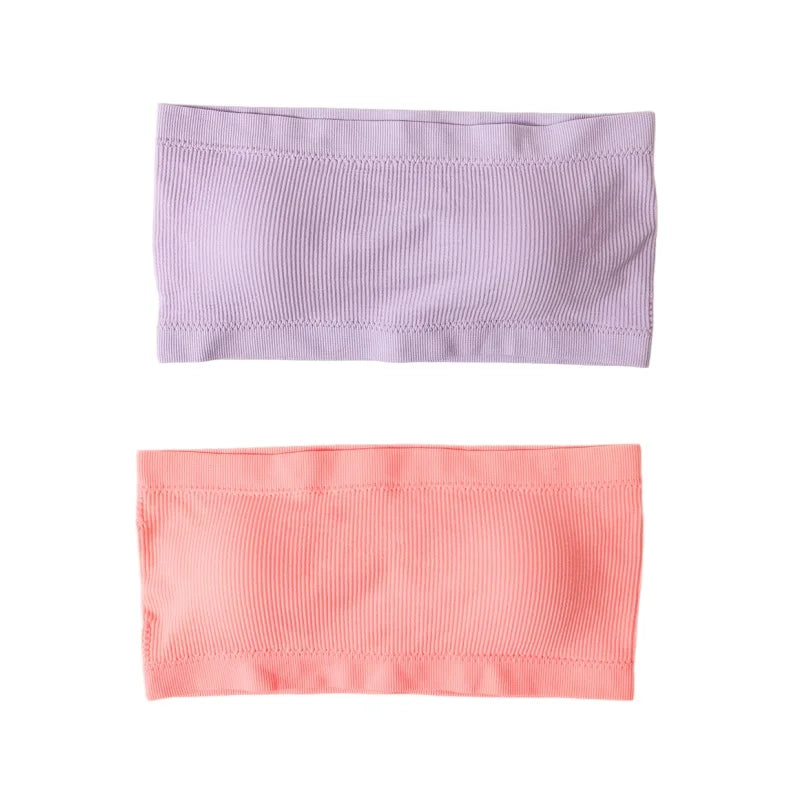 Two ribbed fabric headbands shown flat on a white background, one in light lavender purple and the other in soft coral pink.