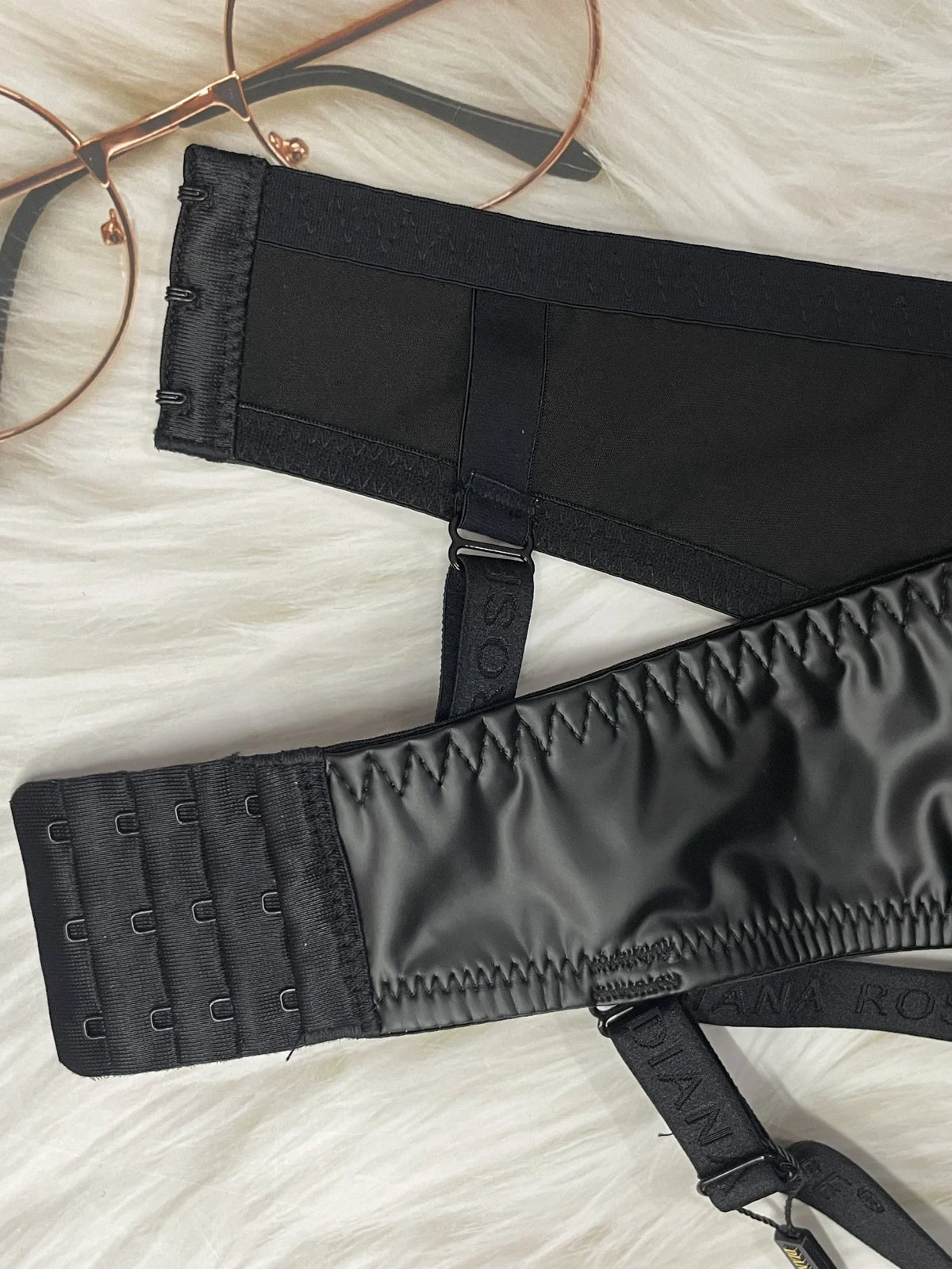 Black bra with straps on a light fabric background