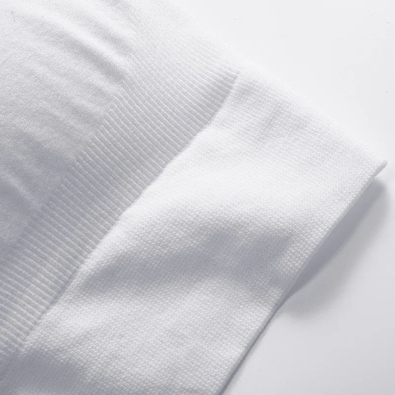 A close-up of a white ribbed knit fabric, showing the texture and fold of the material on a white background.