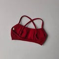 Red bikini top on a gray background