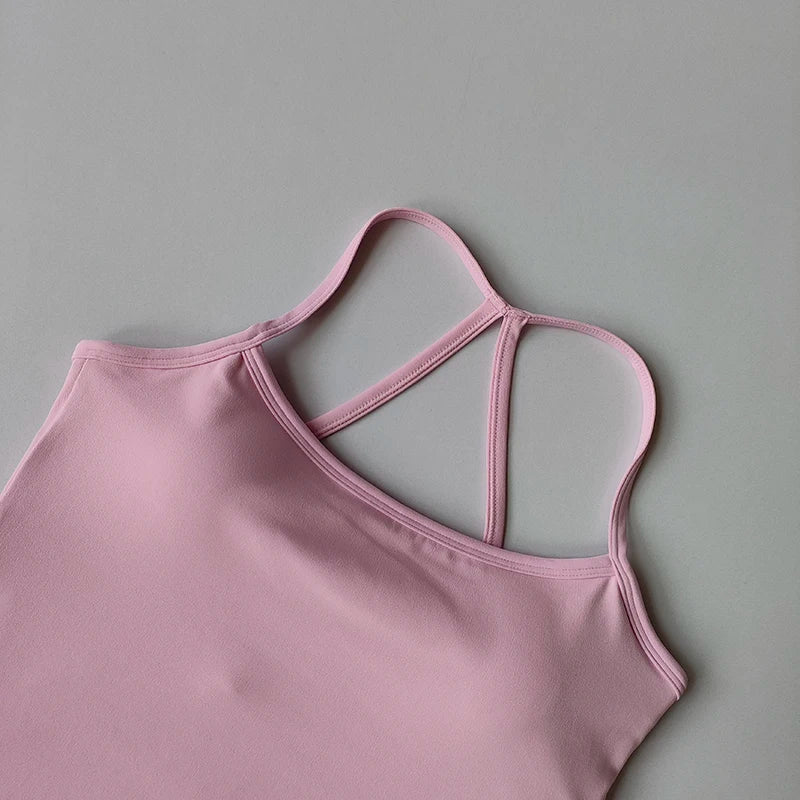 Pink tank top with thin straps on a gray background