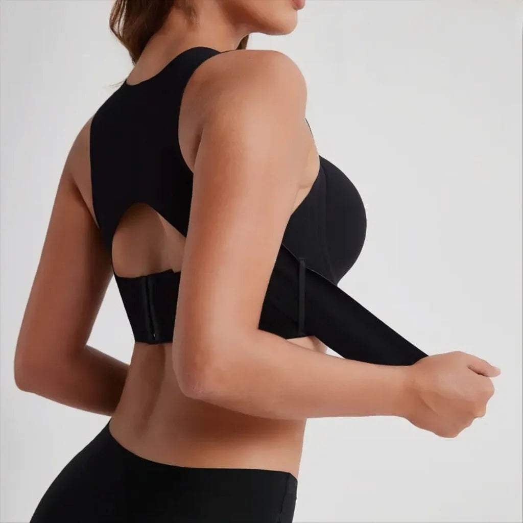 Black sports bra worn by a person on a light gray background
