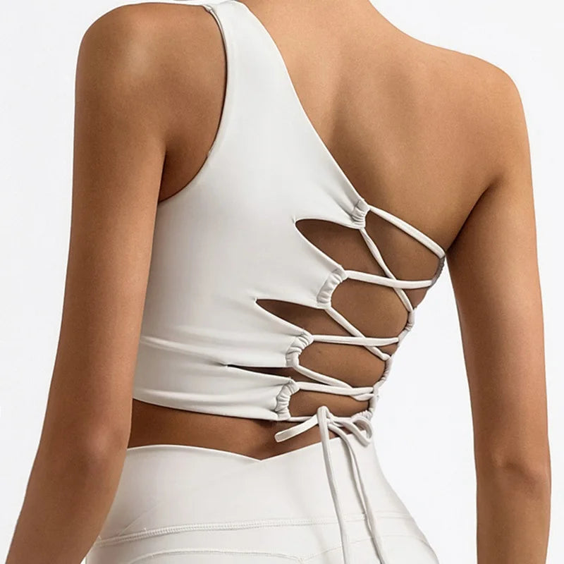 White crop top with strappy back design on a plain background