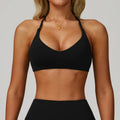 Person wearing a black sports bra and leggings on a plain background