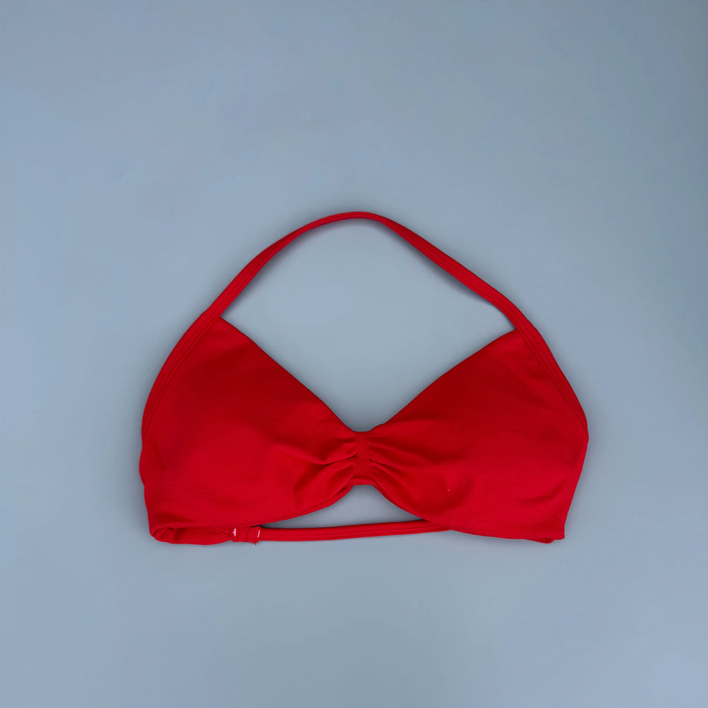 Red bikini top on a gray background