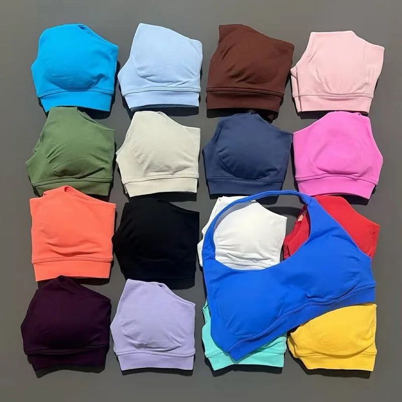 Collection of colorful bras and panties arranged in a grid on a gray background