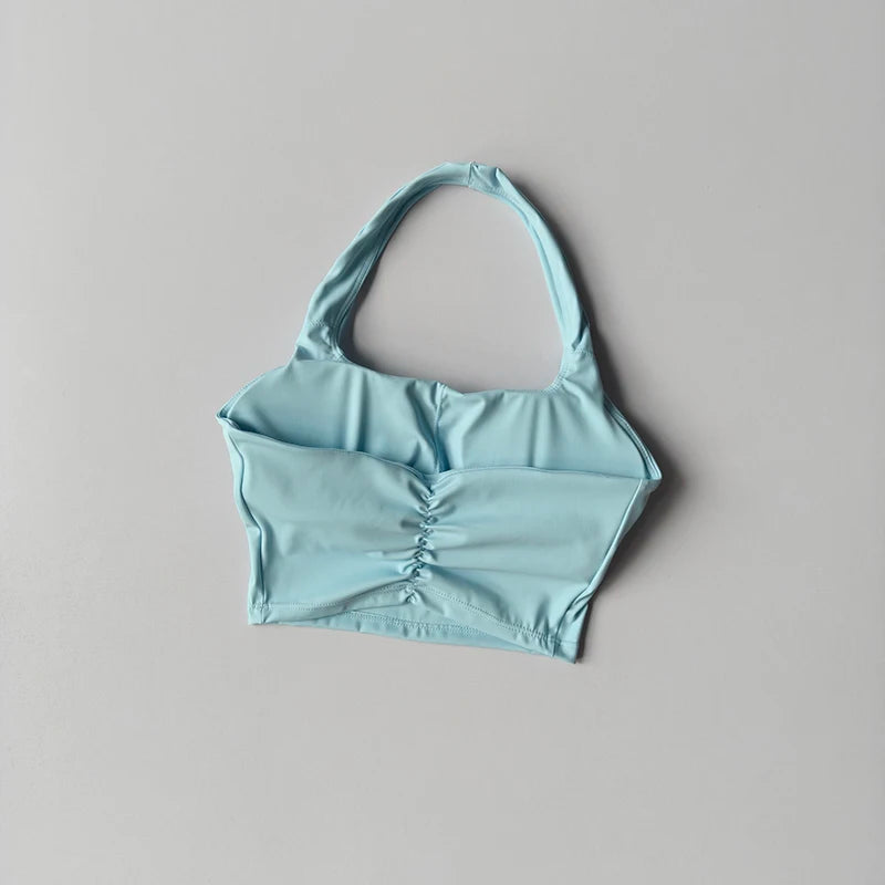 Light blue bikini top on a gray background