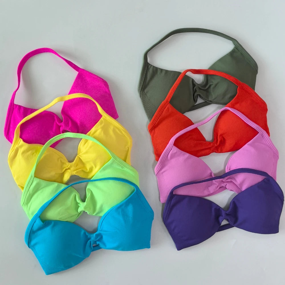 Six colorful bikini top cups arranged in two overlapping groups on a light gray background. The left group includes hot pink, yellow, lime green, and bright blue cups.