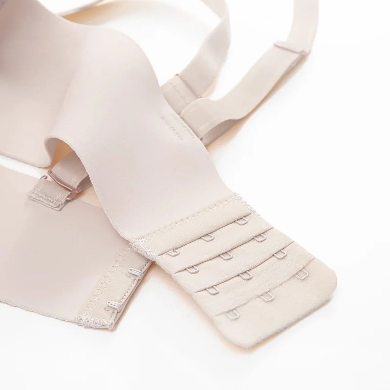 Close-up of a beige wireless bra showing the rear strap adjustment area with multiple hook-and-eye closures on a white background.