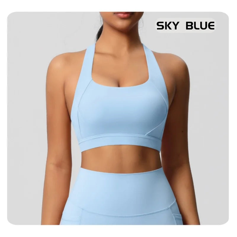 A woman wearing a light sky blue sports bra and matching high-waisted leggings against a light gray background, with the text 'SKY BLUE' in the top right corner.