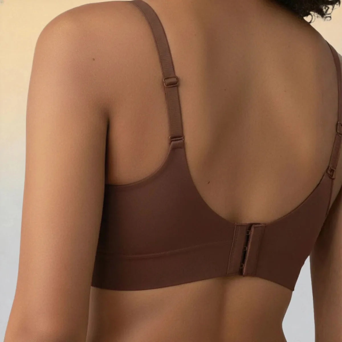 Brown bra worn by a person on a plain background