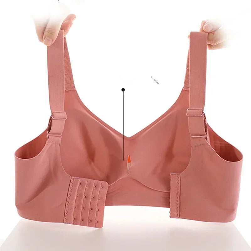 Pink bra with adjustable straps on a white background