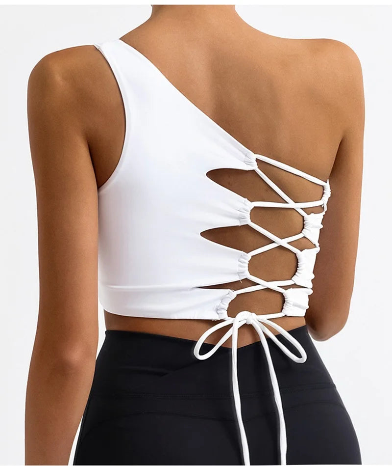 White crop top with lace-up back design on a model against a white background