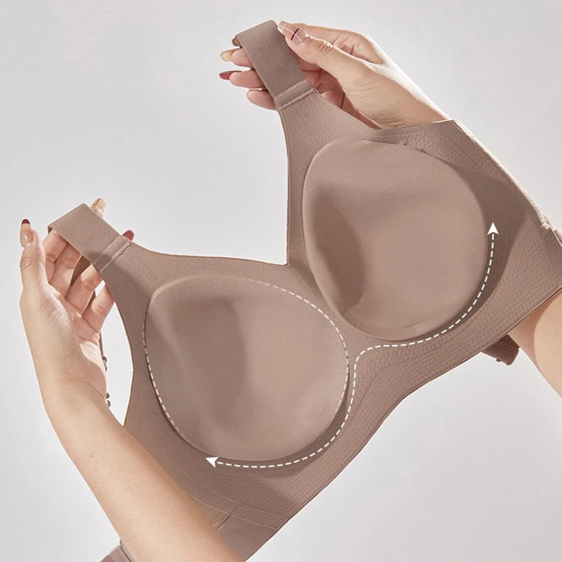 Brown bra held by hands against a light gray background