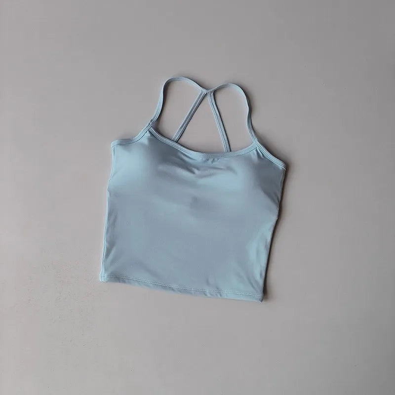 Light blue tank top with thin straps on a gray background