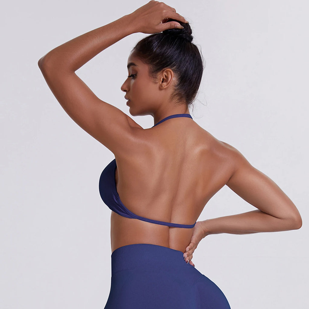 Woman wearing a blue halter top and skirt against a white background