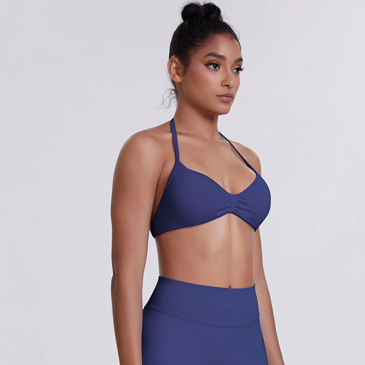 Woman wearing a blue bikini top and skirt on a white background