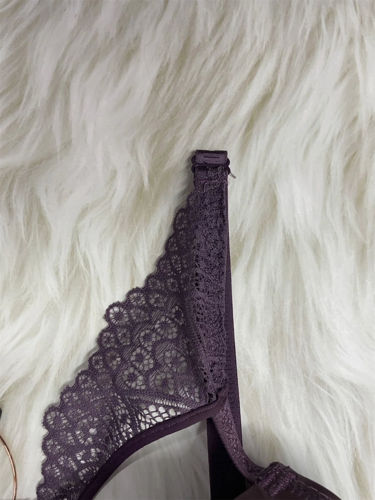 Purple lace lingerie on a white fur background