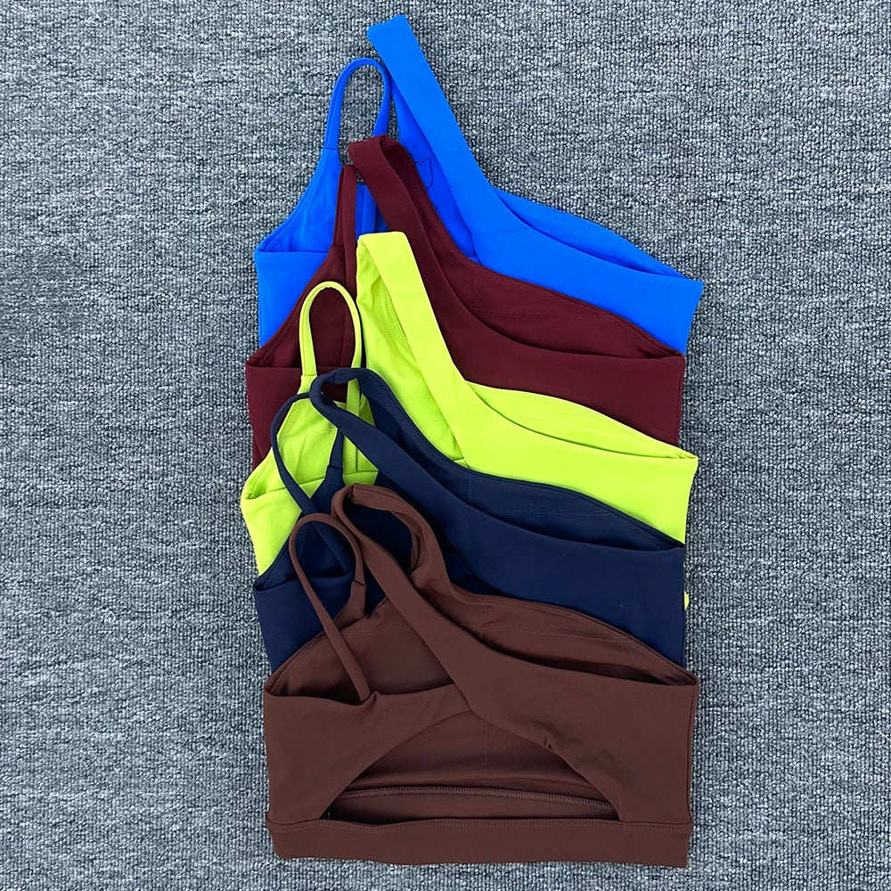Stack of colorful swimsuits on a textured gray background