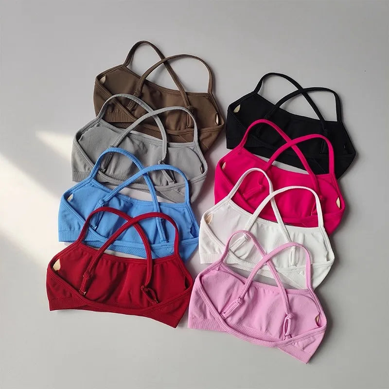Set of colorful bras arranged on a light gray background