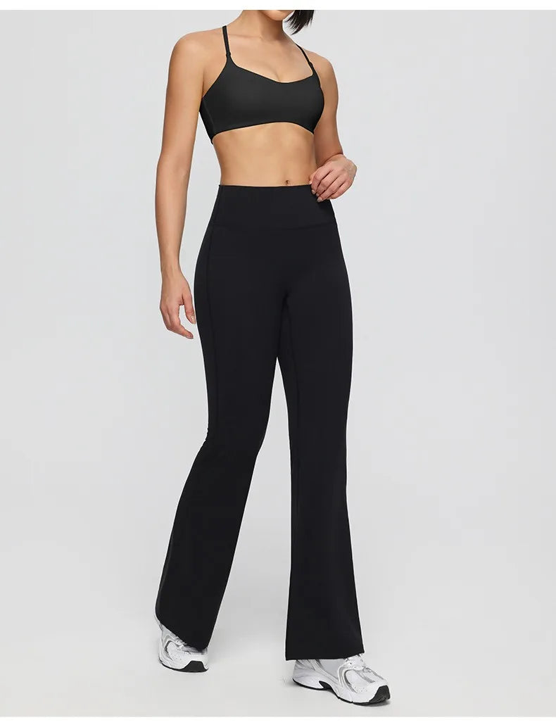 Person wearing a black sports bra and leggings on a white background