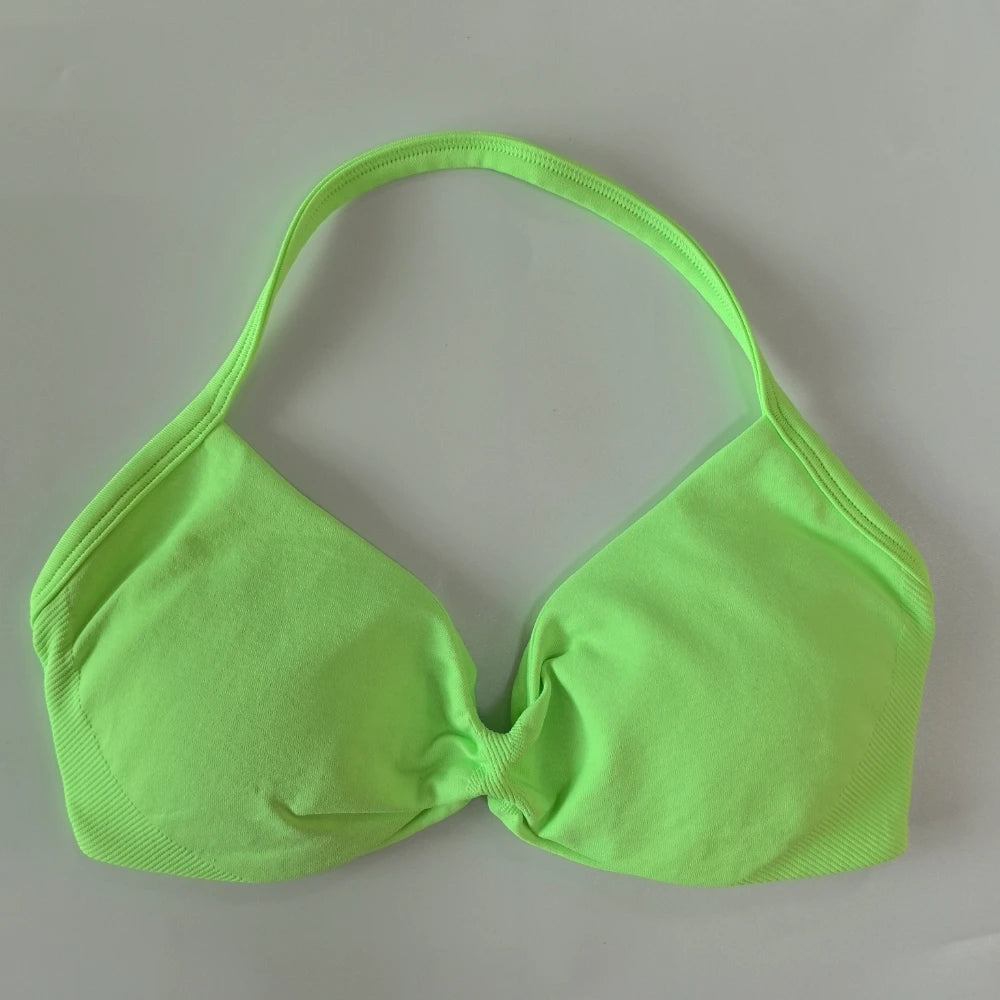 Green bikini top on a gray background