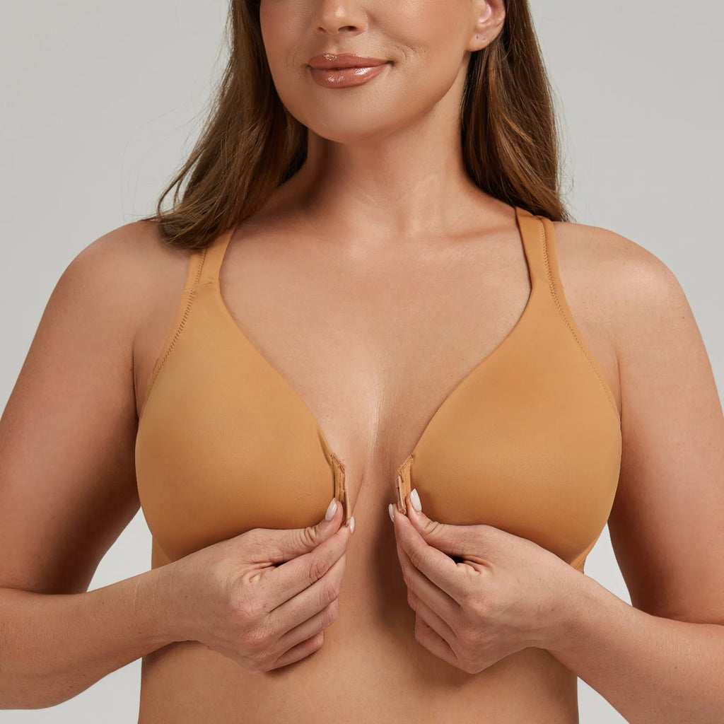 Woman wearing a mustard yellow bra against a plain background