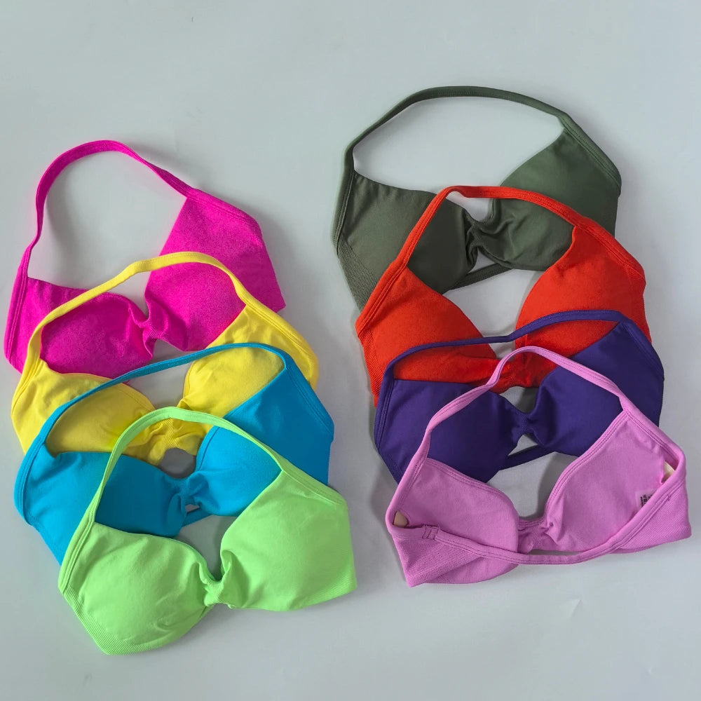 Colorful bikini tops arranged on a light gray background