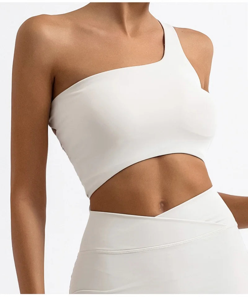 White crop top with cutout design on a plain background
