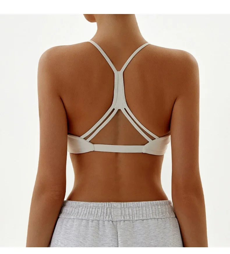 White strappy top worn by a person on a white background
