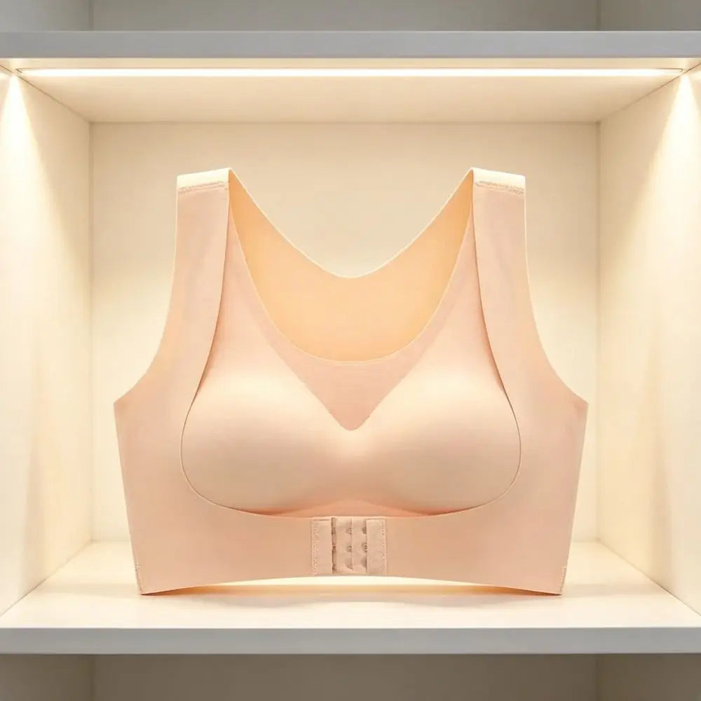 A light peach-beige wireless bra displayed on a white shelf inside a lit display case.