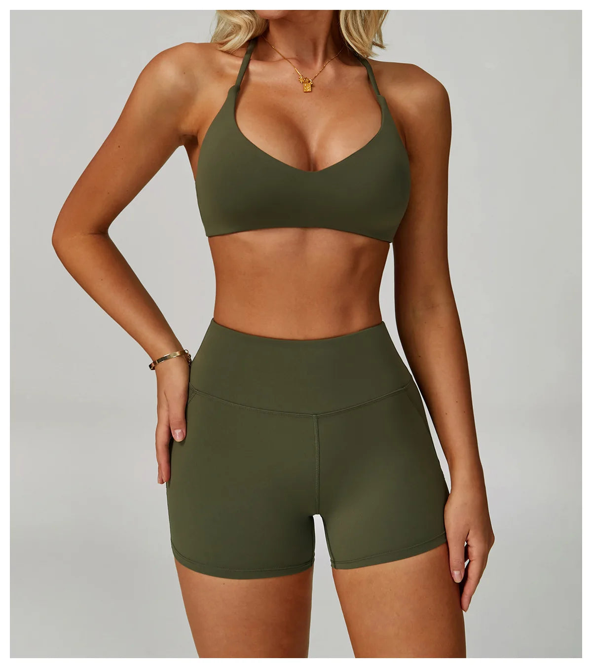 Person wearing an olive green sports bra and shorts set on a neutral background