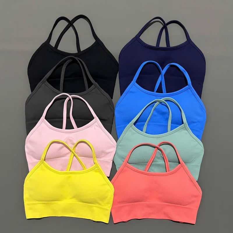 Set of colorful sports bras in various colors on a gray background