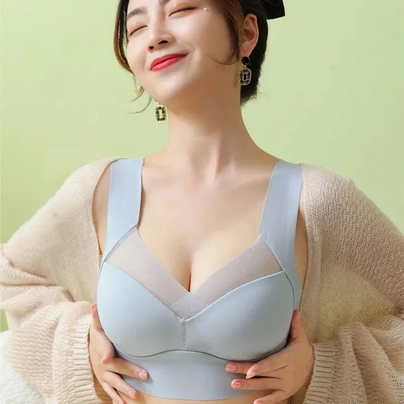 Woman wearing a light blue bra against a green background