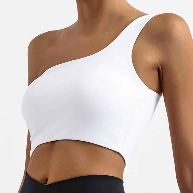 White one-shoulder top worn by a person on a white background