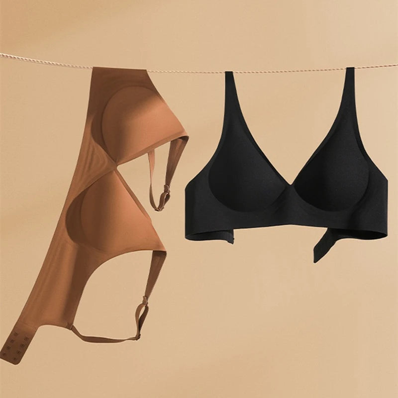 Black and brown bras hanging on a line against a beige background