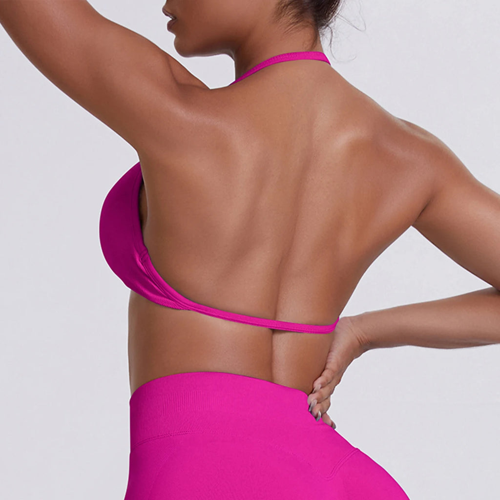 Person wearing a bright pink bikini against a light gray background