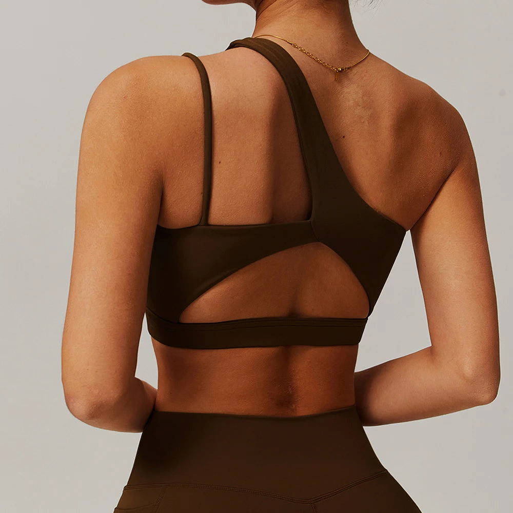 Brown sports bra with mesh panels worn by a person on a plain background