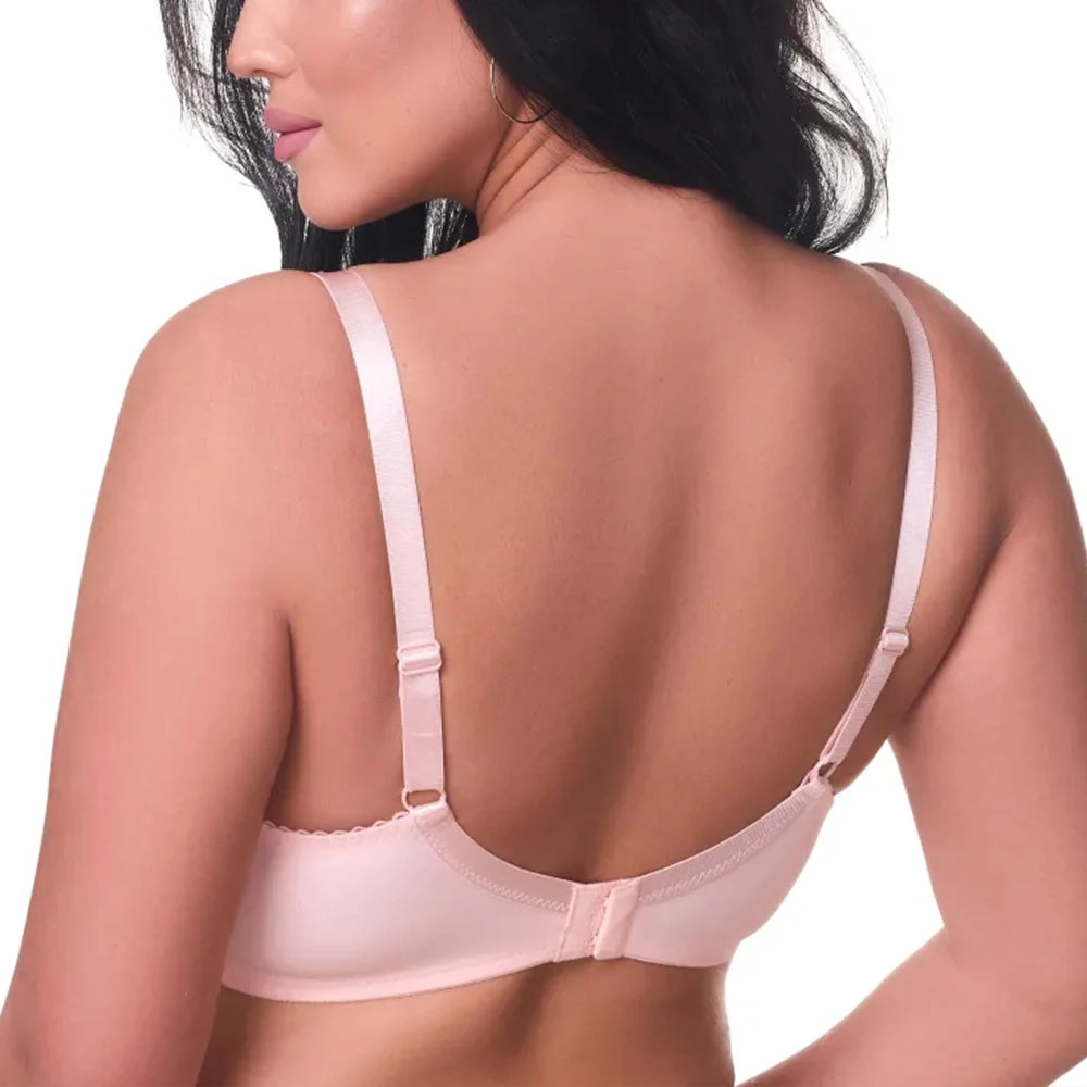 Woman wearing a light pink bralette on a white background