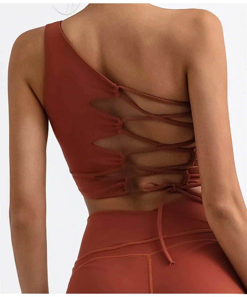 Reddish-brown crop top with open back design on a white background
