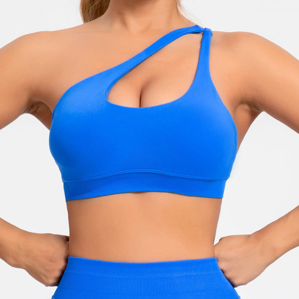 Person wearing a blue sports bra and shorts on a white background